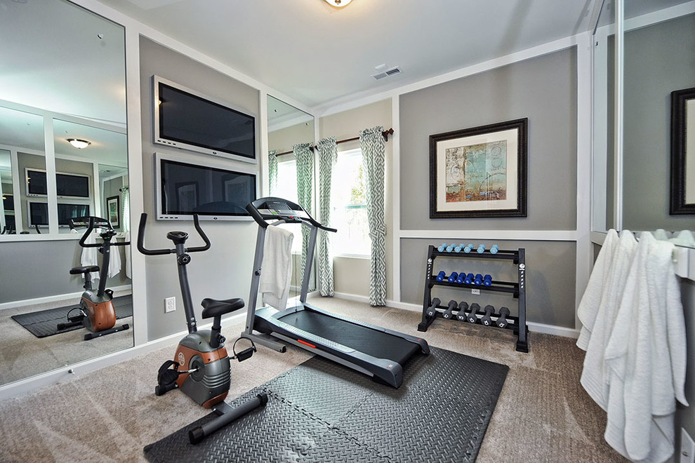 This is an example of a traditional home weight room in Charlotte with grey walls, carpet and grey floors.