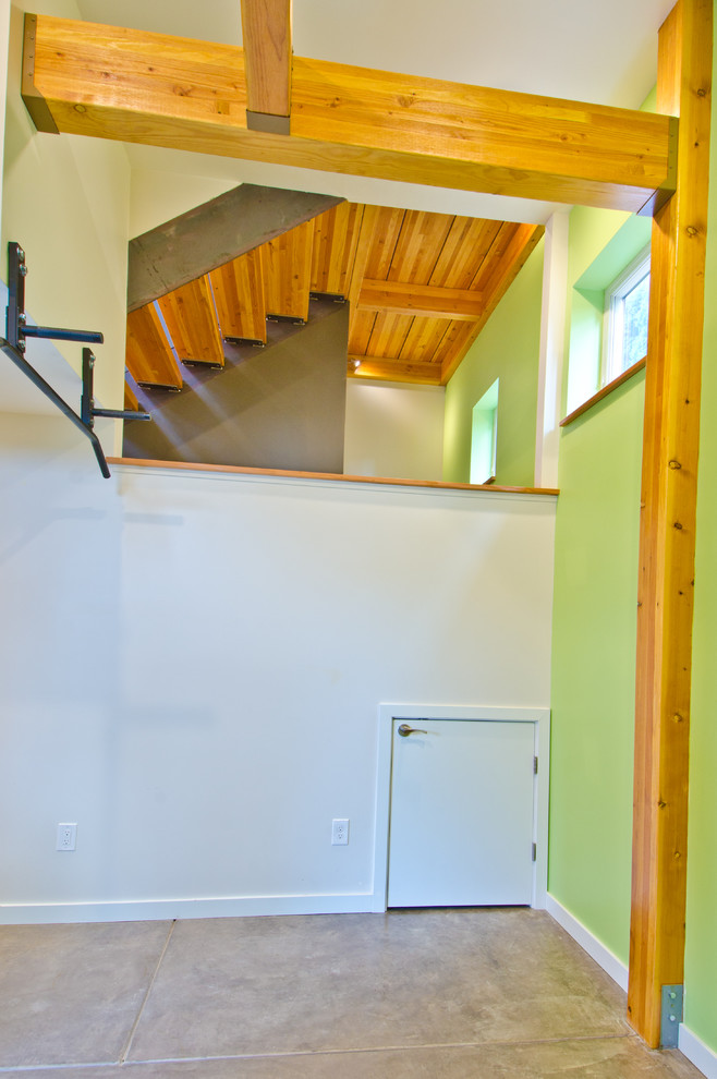 Inspiration for a medium sized modern multi-use home gym in Seattle with green walls and concrete flooring.