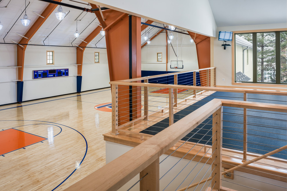 Geräumiger Klassischer Fitnessraum mit Indoor-Sportplatz, weißer Wandfarbe und hellem Holzboden in Philadelphia