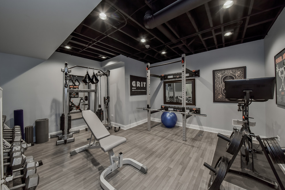Example of a transitional gray floor home gym design in Chicago with gray walls