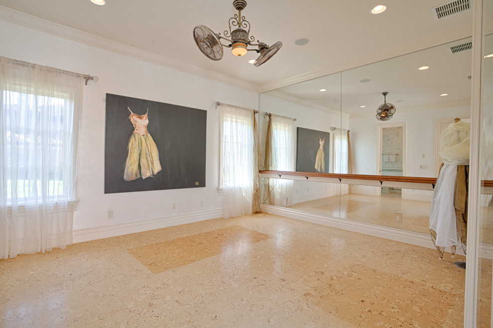 Inspiration for a large mediterranean beige floor home gym remodel in Orlando with white walls