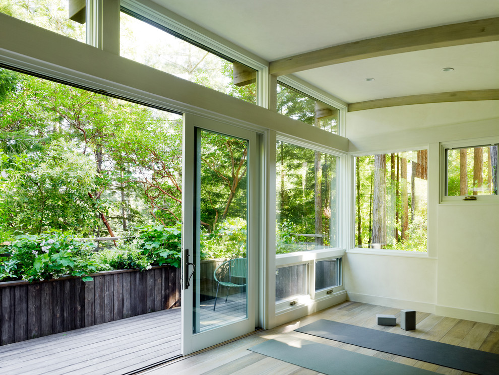 Home yoga studio - contemporary light wood floor home yoga studio idea in San Francisco with beige walls
