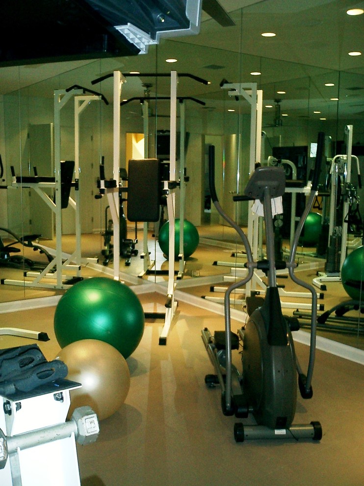 Large modern home gym in San Diego with beige walls and lino flooring.