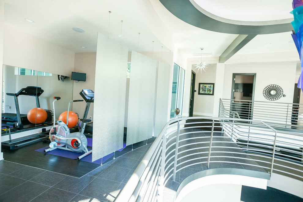 Photo of a small modern multi-use home gym in Orlando with beige walls and porcelain flooring.