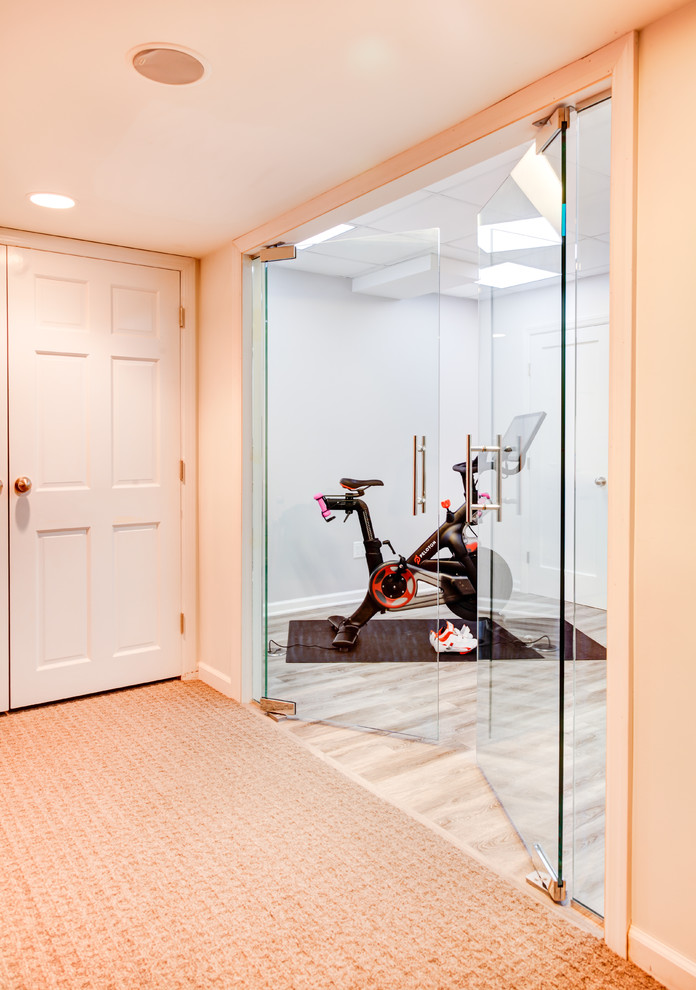 Photo of a medium sized classic multi-use home gym in New York with grey floors.