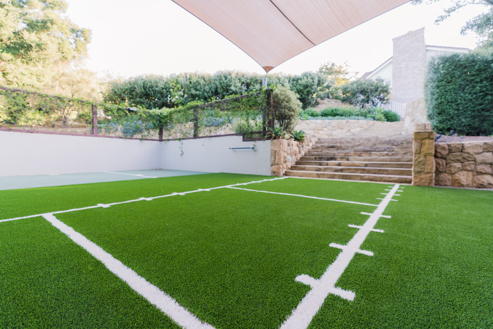 This is an example of a medium sized multi-use home gym in Santa Barbara with green floors.