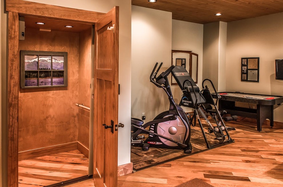 Inspiration for a large traditional multi-use home gym in Other with white walls, medium hardwood flooring and brown floors.