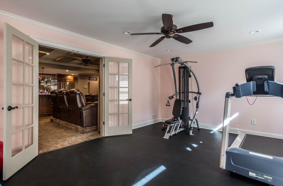 Inspiration for a small rustic black floor multiuse home gym remodel in Atlanta with pink walls
