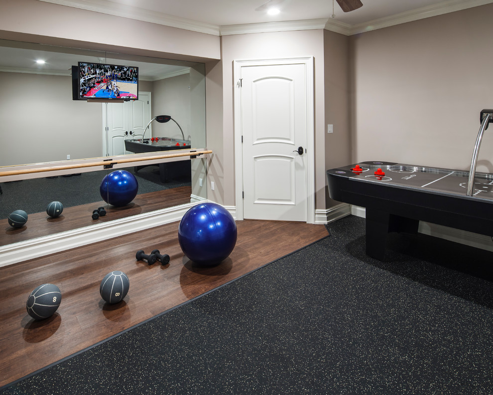 Minimalist dark wood floor multiuse home gym photo in New York with beige walls