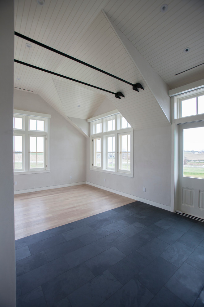 Example of a classic light wood floor home gym design in Other with white walls