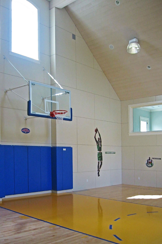 Example of a large classic light wood floor and brown floor indoor sport court design in Boston with beige walls