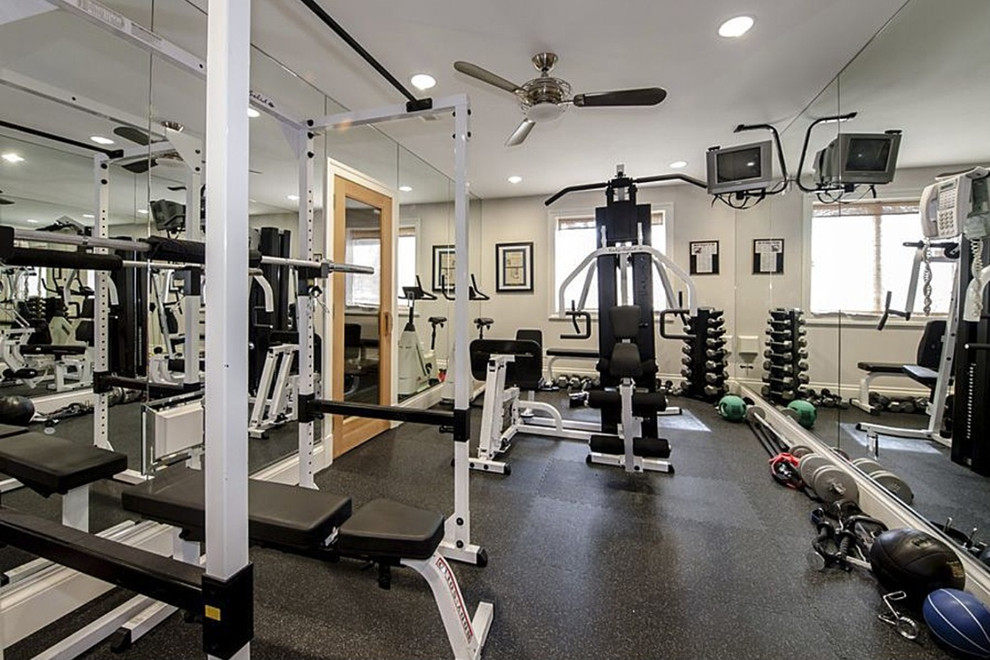 Example of a mid-sized home weight room design in DC Metro with white walls