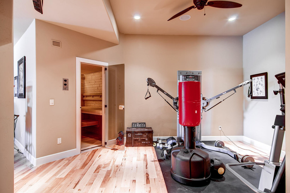 Example of a mid-sized classic light wood floor multiuse home gym design in Denver with beige walls
