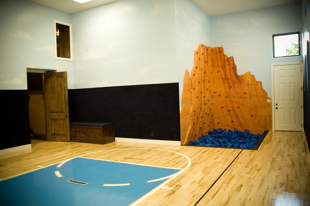 Large classic indoor sports court in Salt Lake City with multi-coloured walls and plywood flooring.