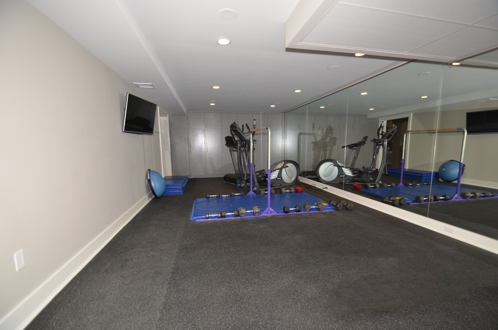 Medium sized home weight room in New York with grey walls and cork flooring.