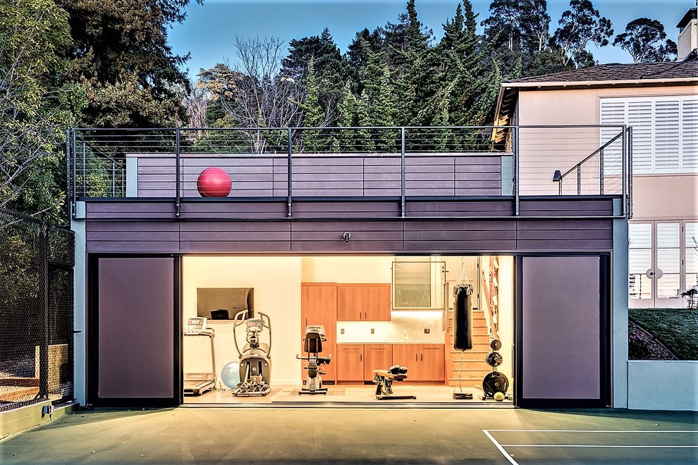 This is an example of an industrial home gym in San Francisco with white walls.