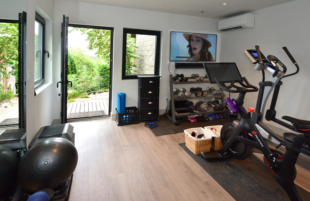 Photo of a medium sized contemporary multi-use home gym in Seattle with white walls, vinyl flooring and grey floors.