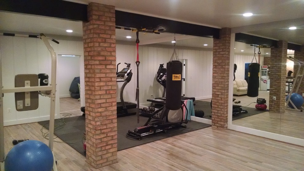 Multiuse home gym - mid-sized traditional light wood floor and beige floor multiuse home gym idea in DC Metro with white walls