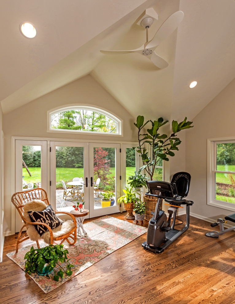 Photo of a medium sized traditional multi-use home gym in Milwaukee with beige walls, medium hardwood flooring and brown floors.