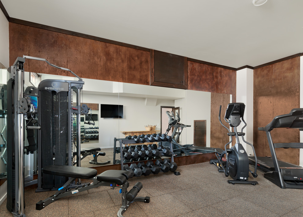 This is an example of a medium sized rustic home gym in Vancouver with vinyl flooring, brown walls and grey floors.