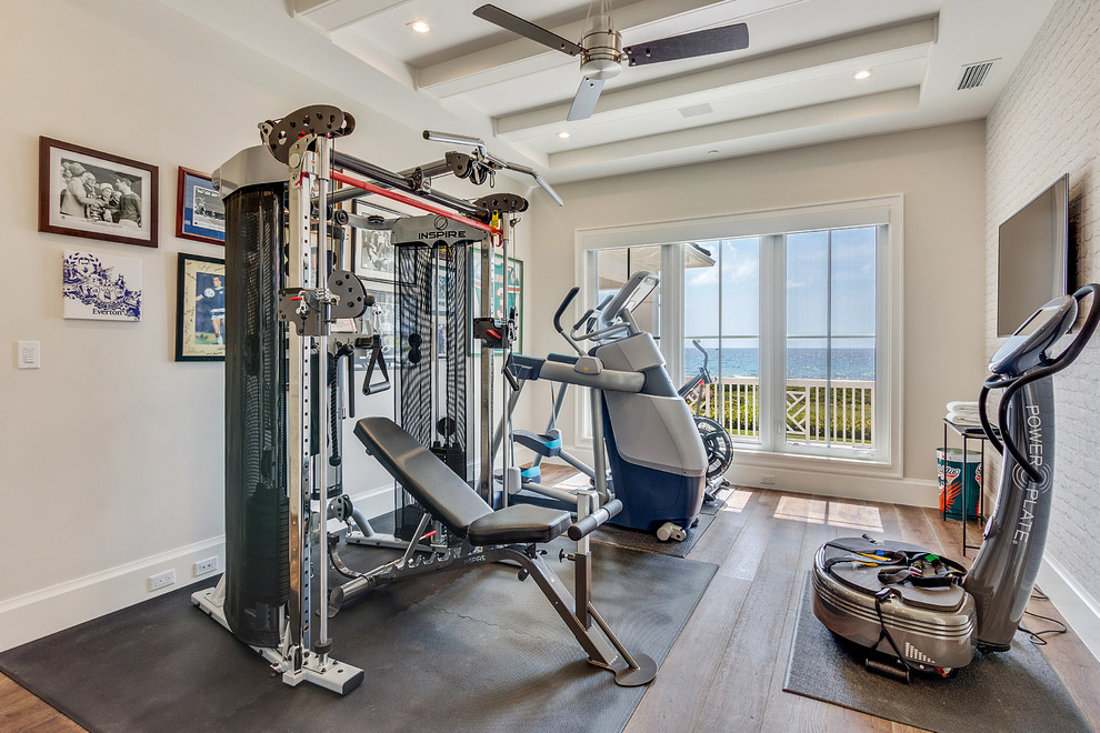 Multiuse home gym - mid-sized coastal medium tone wood floor and brown floor multiuse home gym idea in Miami with beige walls
