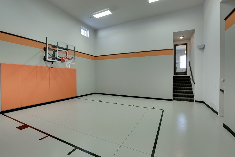 Large classic indoor sports court in Minneapolis with grey walls, concrete flooring and grey floors.
