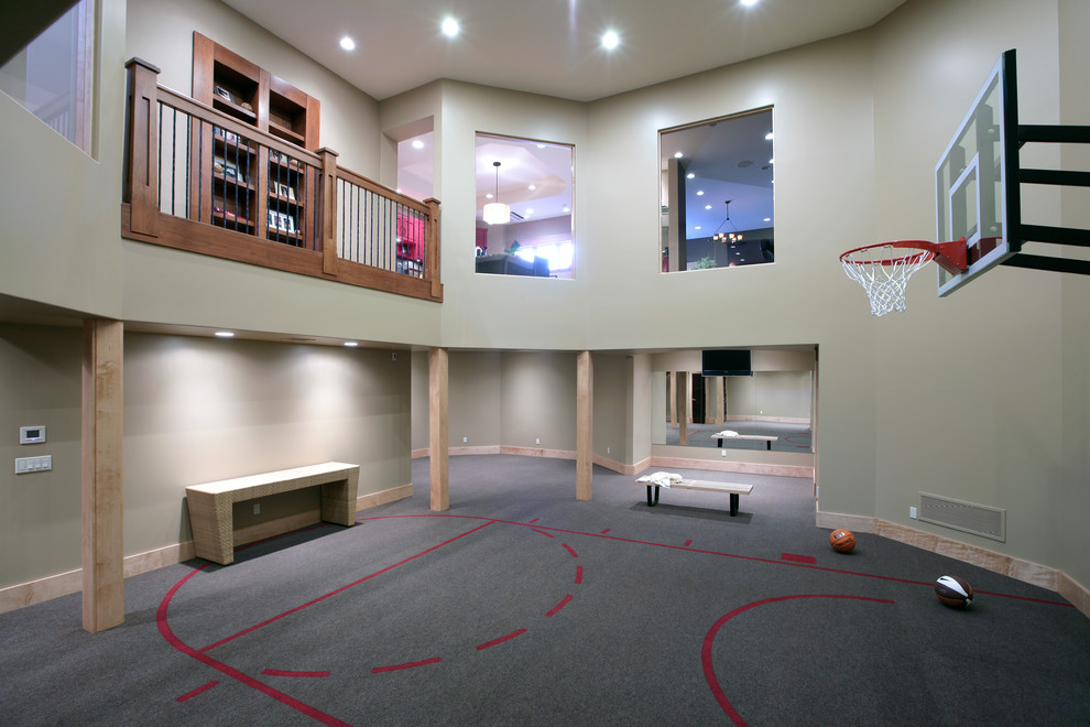 Expansive traditional indoor sports court in Grand Rapids with grey walls, grey floors and feature lighting.