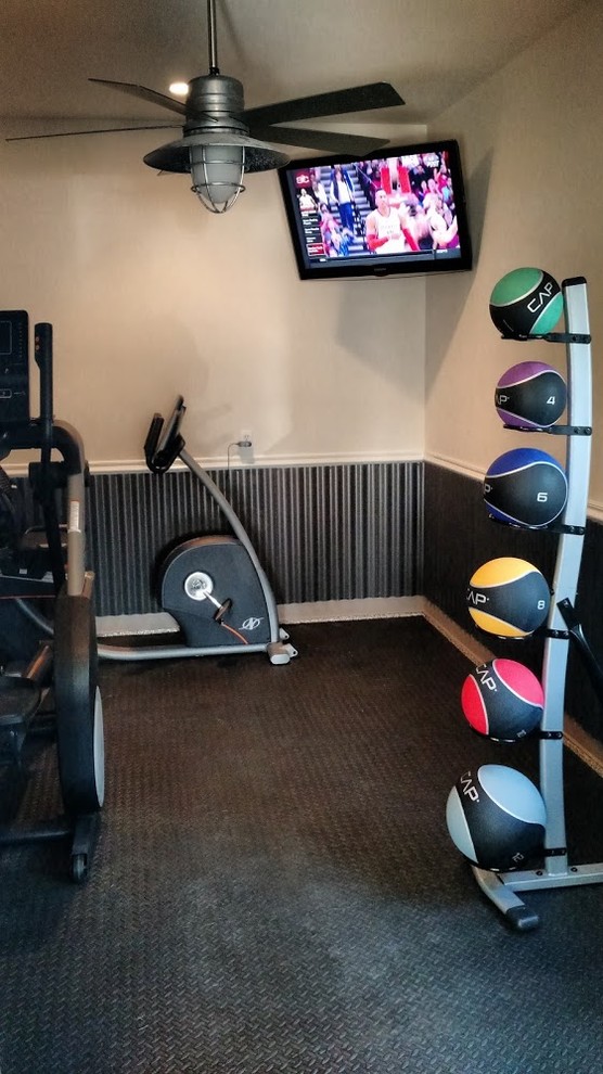 Photo of a traditional multi-use home gym in Houston with white walls.