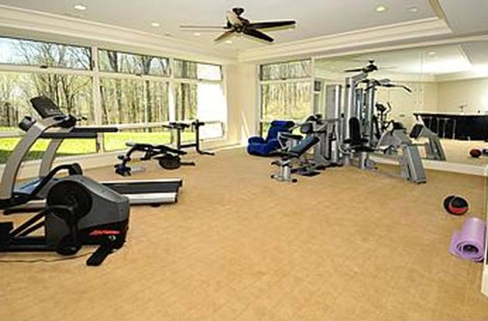 This is an example of a medium sized contemporary multi-use home gym in Philadelphia with beige walls and carpet.