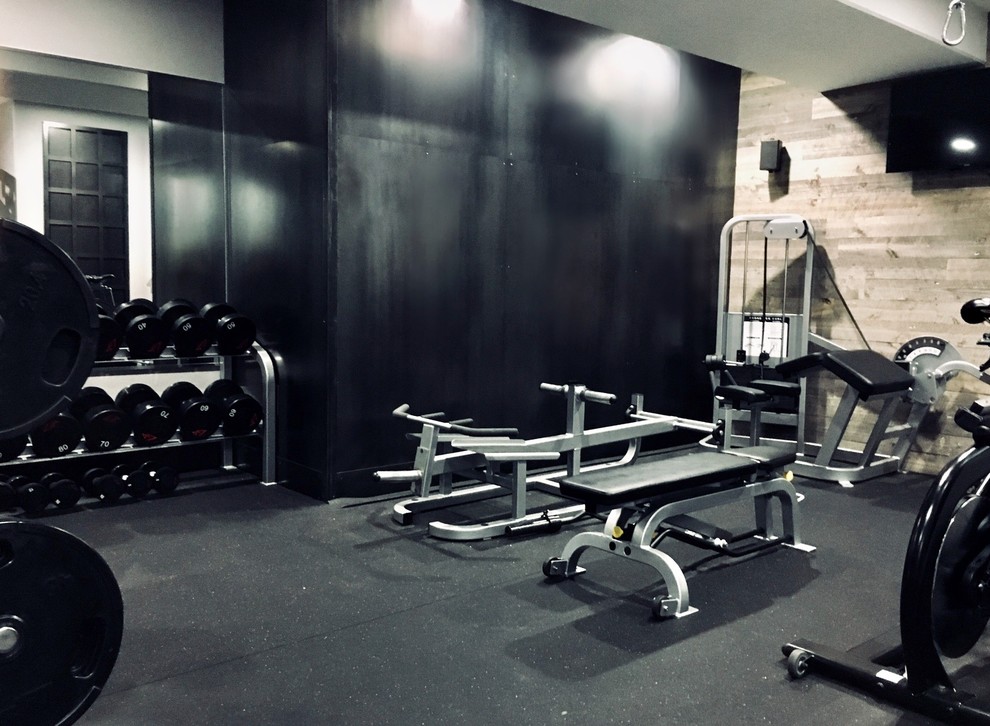Inspiration for a medium sized urban home weight room in Salt Lake City with black floors.