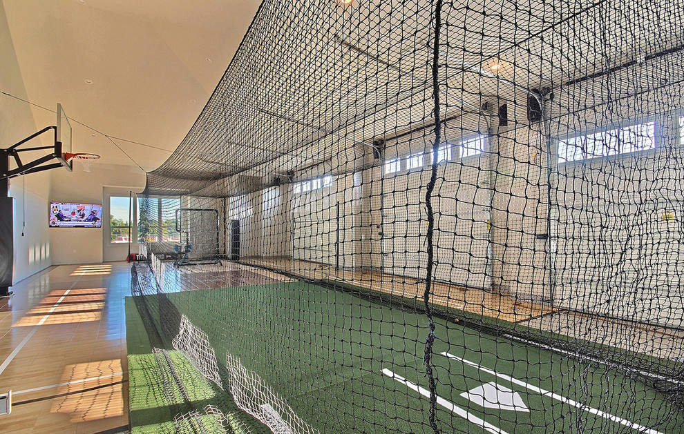Large country indoor sports court in Portland with beige walls, light hardwood flooring and multi-coloured floors.