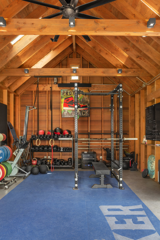 Design ideas for a small country multi-use home gym in Austin with brown walls, concrete flooring and grey floors.