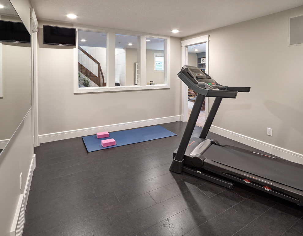 Classic multi-use home gym in Edmonton with beige walls and cork flooring.