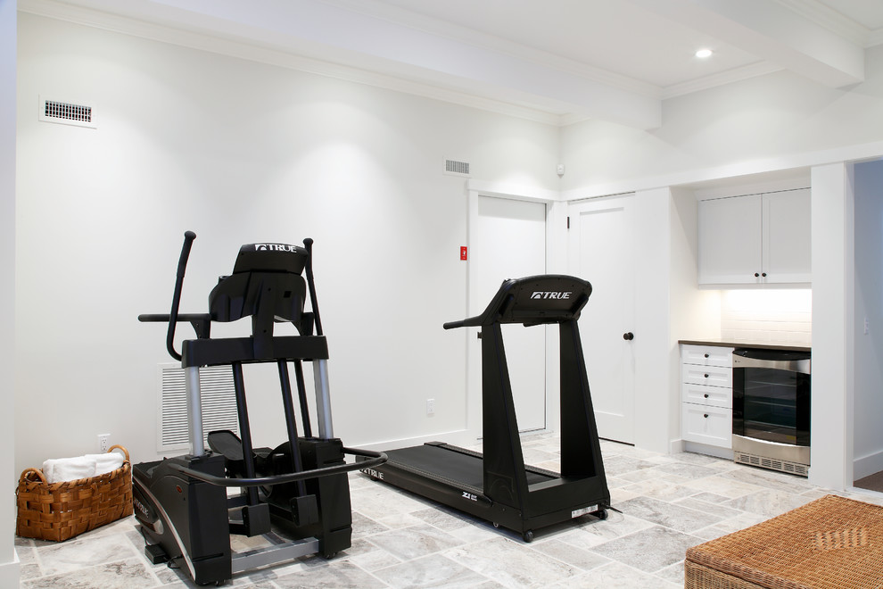 Home weight room - large traditional travertine floor and gray floor home weight room idea in Manchester with white walls