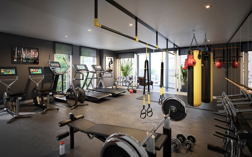 Moderner Fitnessraum mit grauer Wandfarbe, Teppichboden und grauem Boden in London