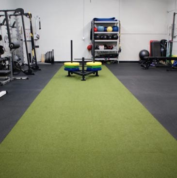 Example of a large multiuse home gym design in Minneapolis with white walls