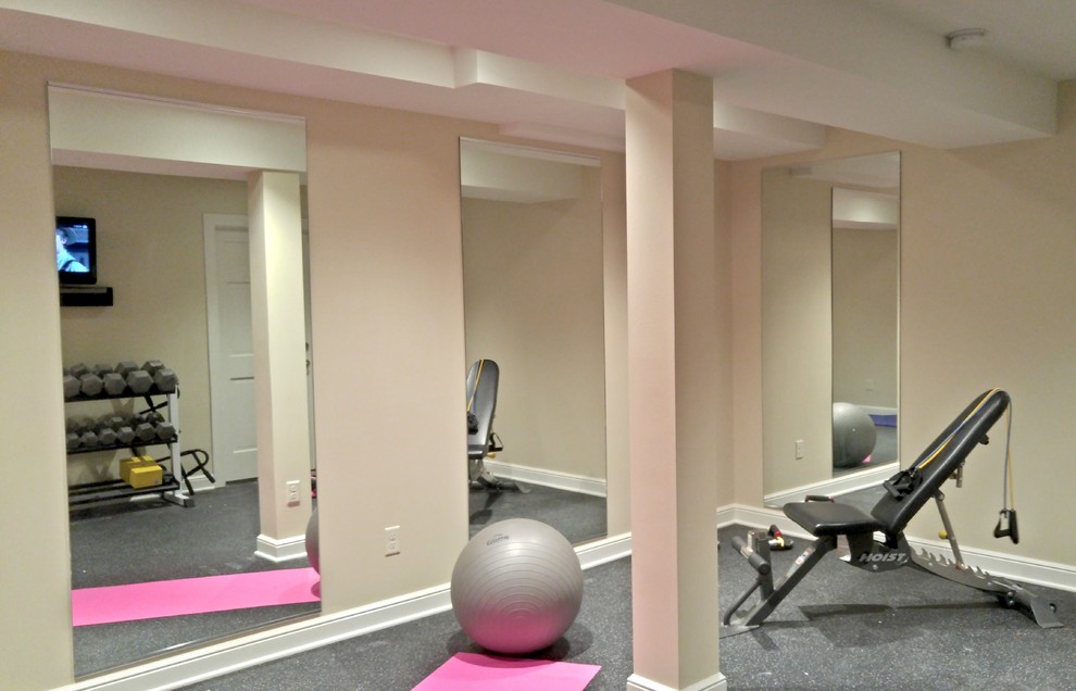 Photo of a small contemporary multi-use home gym in Milwaukee with beige walls and cork flooring.