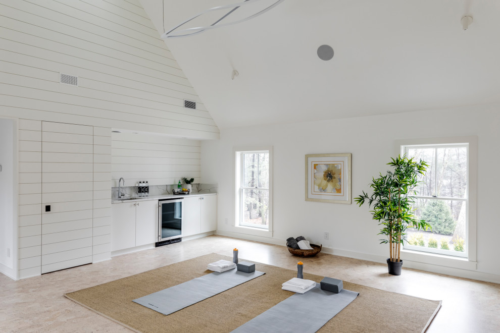 Large rural home yoga studio in Boston with white walls, beige floors, a vaulted ceiling and a feature wall.