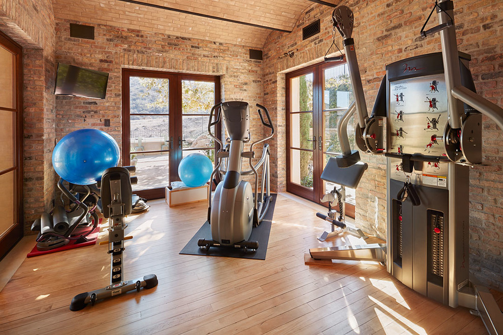 Mid-sized tuscan light wood floor multiuse home gym photo in Orange County
