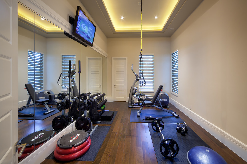 Design ideas for a traditional home weight room in Orlando with beige walls, dark hardwood flooring, brown floors and a feature wall.