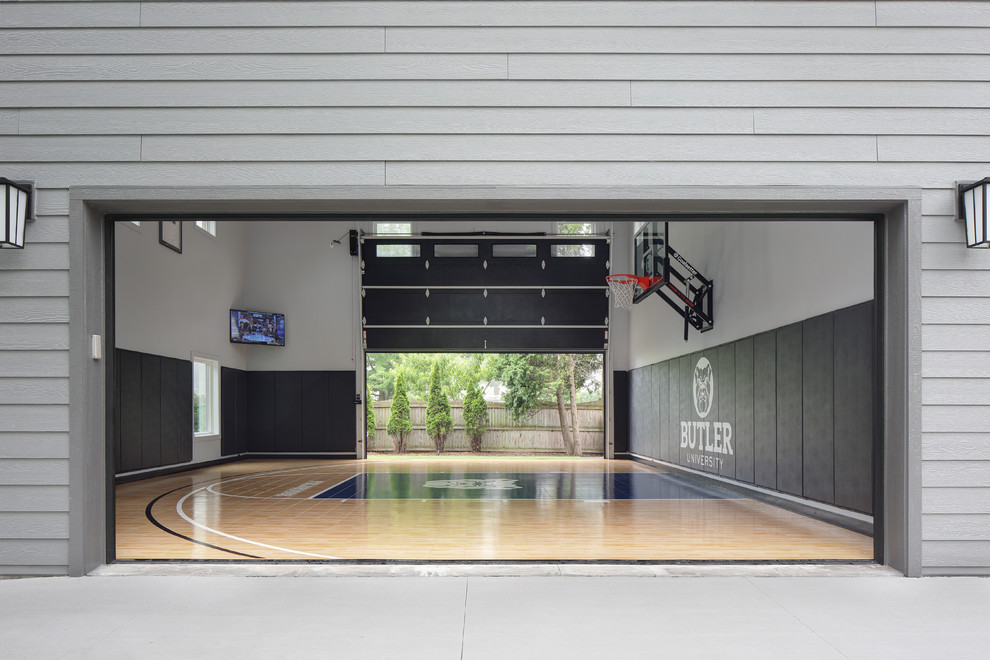 Immagine di un grande campo sportivo coperto chic con pareti grigie, pavimento in vinile e pavimento blu