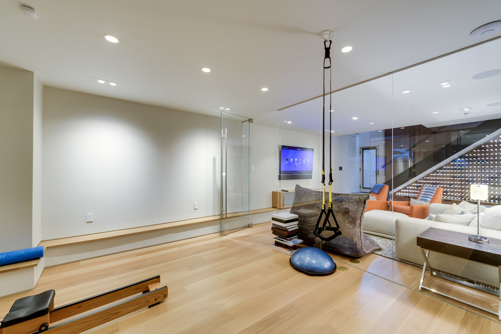 Design ideas for a large contemporary multi-use home gym in DC Metro with beige walls, light hardwood flooring and brown floors.