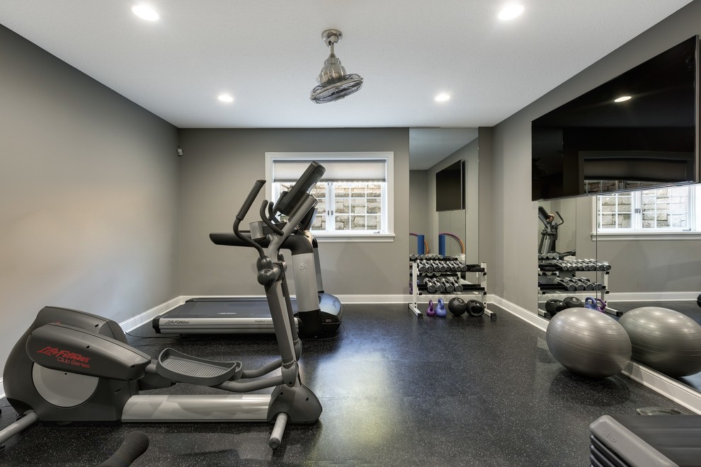 Photo of a large traditional multi-use home gym in Minneapolis with grey walls, lino flooring and black floors.