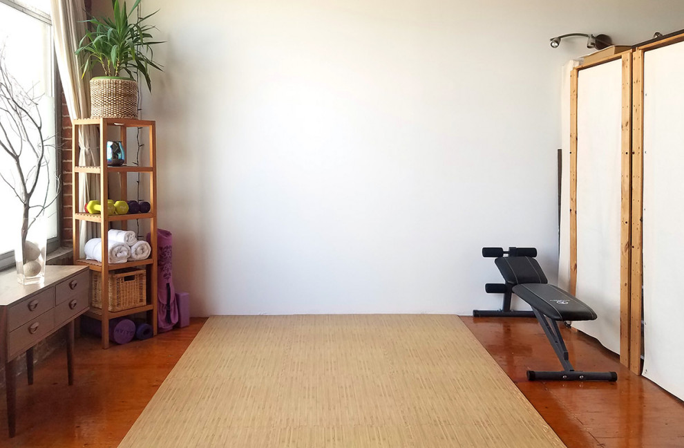 This is an example of a medium sized contemporary home yoga studio in San Francisco with white walls, bamboo flooring and beige floors.