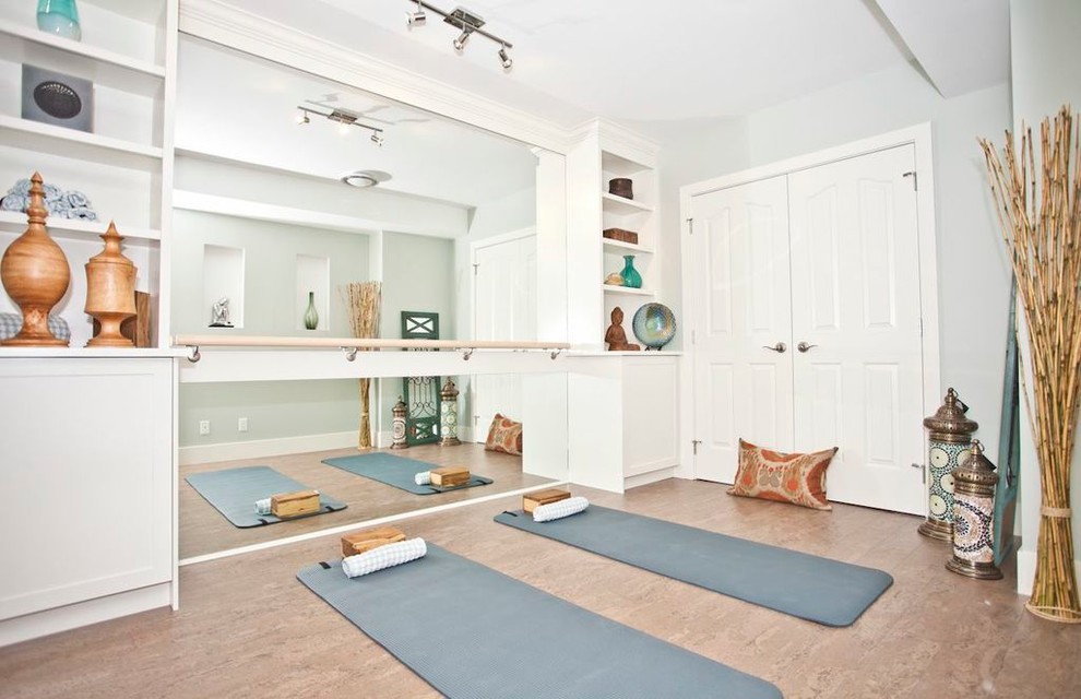 World-inspired home yoga studio in Calgary with white walls and feature lighting.