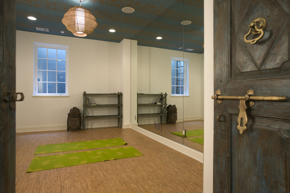 Mediterranean home yoga studio in Minneapolis with white walls, cork flooring and feature lighting.