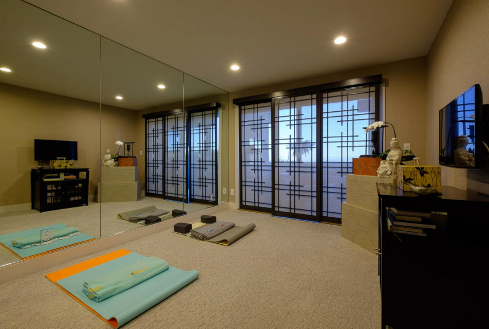 Home yoga studio - mid-sized asian carpeted and beige floor home yoga studio idea in Los Angeles with beige walls