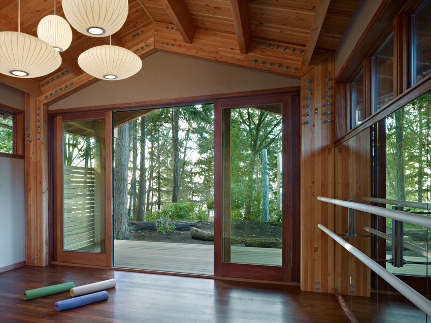 Modern home yoga studio in Seattle with feature lighting.