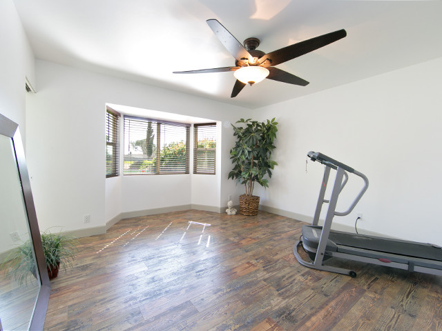 Photo of a midcentury home gym in Orange County.
