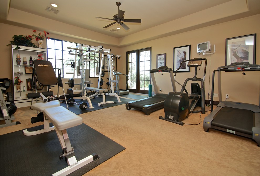 Home weight room - large mediterranean carpeted home weight room idea in Phoenix with beige walls